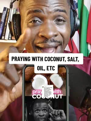 A man with headphones is the main subject, smiling and pointing. Overlayed text says "PRAYING WITH COCONUT, SALT, OIL, ETC." In the background, there's a shelf with books and some flags.