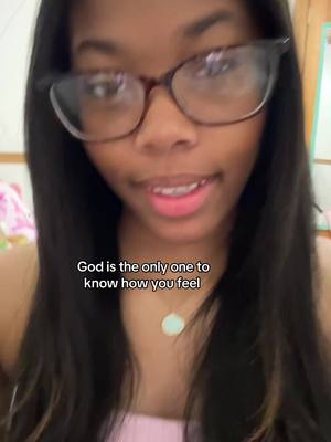 A close-up shot of a young woman with glasses is shown with a background of a room. She is looking directly at the camera and slightly smiling. Overlayed text reads, "God is the only one to know how you feel."