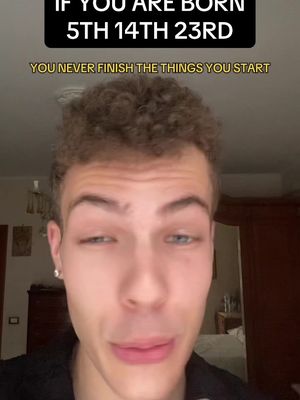 A selfie-style video cover with a young man gazing at the camera with a slightly questioning expression. Above him is a black banner with white text that reads, "IF YOU ARE BORN 5TH 14TH 23RD" and below the text reads "YOU NEVER FINISH THE THINGS YOU START". The background is blurred, suggesting the video is filmed indoors. The overall color scheme is neutral, focusing on the subject's face.