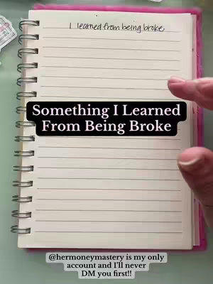 The cover image shows a spiral-bound notebook opened to a spread with lined pages. The notebook is pink, and the pages have writing on them. An overlay with the text "Something I Learned From Being Broke" appears on the lower part of the open spread, in a bold, black font and opaque white box. In the top right corner of the spread, a hand holding a pen is visible. Below the open notebook is the handle of a mobile device and a statement in a clear black font.