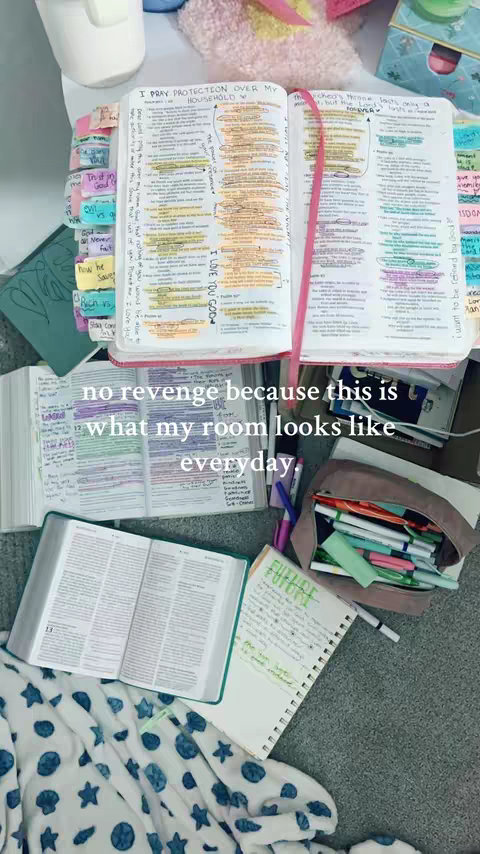An overhead shot showcasing a cluttered desk or table with various open books, notebooks, and writing supplies scattered across. The scene is lit with natural light, with a focus on the annotations and highlighting within the books.