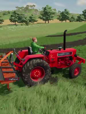 An image of a red tractor driving through a green field. A person is in the driver's seat. The background has trees and some hills.