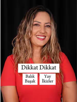 A woman with long wavy hair smiles brightly at the camera. She is wearing a red top. Behind her is a black background and three white rectangles with text overlayed.