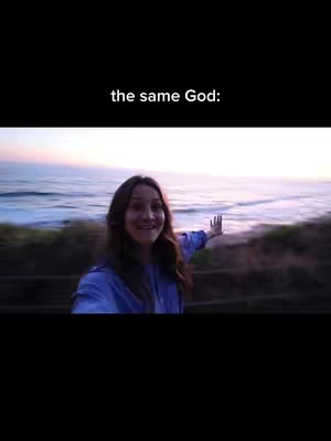 A woman stands with her arm extended in a selfie video at the beach at dusk, text appears at the top of the image.