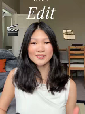 The cover image is a selfie-style shot featuring a young woman. She is centered in the frame, smiling and looking directly at the viewer. Above her head, the text overlay reads "Edit" in a script font. On either side of her are small graphic elements; a film clapboard on the left and a film roll on the right. The setting appears to be a home interior, providing a soft, neutral background that keeps the focus on the woman and text elements.
