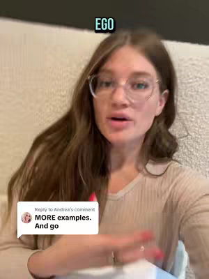 A woman with long brown hair and glasses is speaking directly to the camera. Text overlayed on the top of the image reads: EGO. A comment section from another user is visible on the bottom - the comment text reads MORE examples And go.