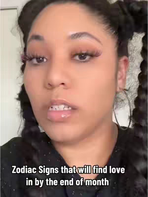 A close-up shot of a woman with dark hair in pigtails, wearing makeup, and is looking at the camera. Text overlayed on the bottom is 'Zodiac Signs that will find love in by the end of the month'.