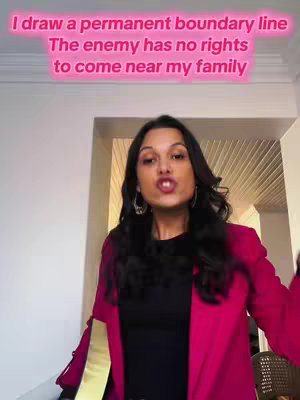 A woman with long black hair and wearing a pink blazer is speaking to the camera, with overlaid text in a pink gradient font above her head. The background features a doorway and white walls.