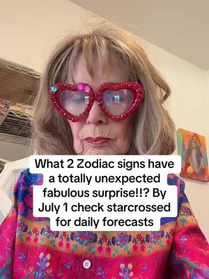 A woman with light blonde hair, wearing large, red, heart-shaped glasses adorned with gems, is positioned in a close-up shot. She wears a brightly colored top with floral patterns. Text overlay on the image provides a message about zodiac signs and daily forecasts.