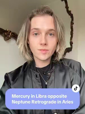 The image shows a person with light hair and a black jacket in front of a wall and decorative mirror. A text overlay appears at the bottom, within a purple rectangle, with the text 'Mercury in Libra opposite Neptune Retrograde in Aries'.
