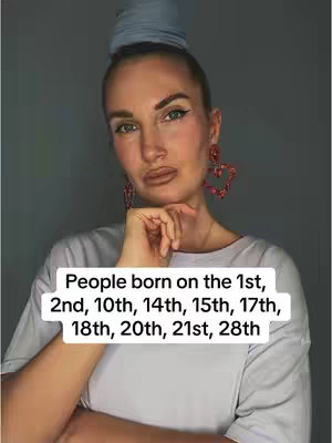 A woman with a bun hairstyle and large heart-shaped earrings poses, resting her chin on her hand. Text overlay lists birth dates.