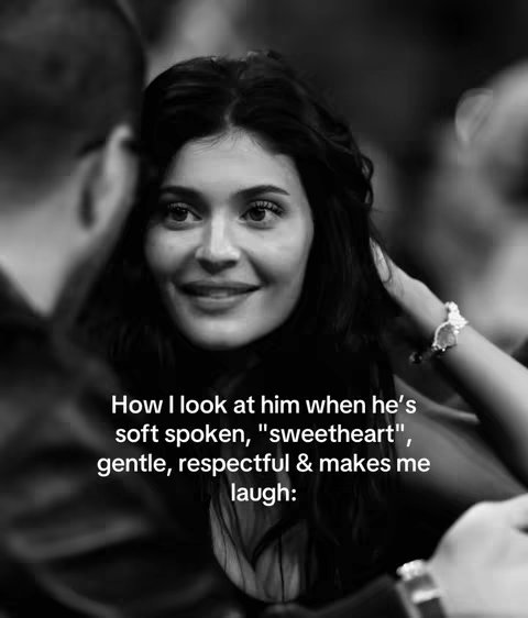 A black and white photo featuring Kylie Jenner gazing lovingly at someone out of frame. She has her hand on her cheek and is smiling. Text overlays the image.