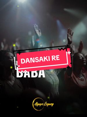 The image shows a crowd of people with their hands raised, likely in a concert or worship setting, with stage lighting and a blurred background. A red and white text overlay reads "DANSAKI RE" in a bold font. Below it, there is another text "DADA". There is a logo at the bottom.