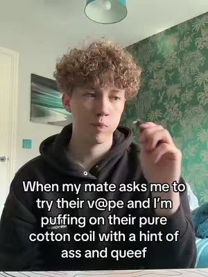 A young man with curly hair wearing a black hoodie is holding a vape pen and looking at the camera. Text overlay explains a relatable situation with a humorous tone.