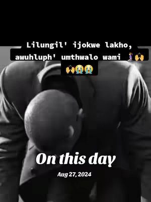 A black and white image of a person's head in prayer or deep thought, with their head bowed forward, and their arms are slightly visible. Text overlays appear at the top and bottom of the image in white. At the top it says, "Lilungil' ijokwe lakho, awuhluph' umthwalo wami" with some emojis . At the bottom, it says "On this day Aug 27, 2024".
