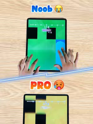 The cover image is split horizontally. The top half shows a person's hands playing a game on a tablet, with the game interface visible and the word 'Noob' with a crying emoji above the screen. The bottom half shows another tablet with a similar game interface and the word 'Pro' with a face sweating emoji, indicating different levels of skill. The tablet is above a light brown wooden surface.