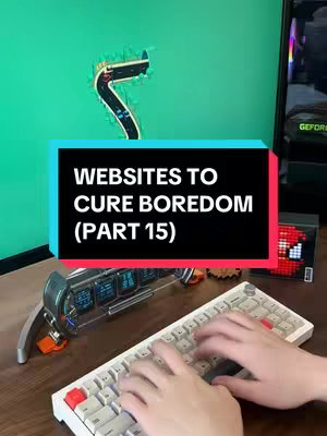 The image shows a person typing on a white keyboard. In the background, there's a computer monitor displaying a road game. A text box is overlaid with the words "WEBSITES TO CURE BOREDOM (PART 15)". A decorative item is visible on the desk to the side of the keyboard.
