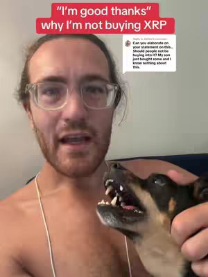 A selfie-style shot of a man with glasses looking at the camera, with a dog at the bottom right of the frame. Text bubble overlays appear above the man's head and to the right, suggesting a question and answer scenario in the video's content. The man appears shirtless, and the dog has its mouth open and teeth visible.