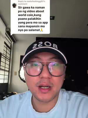A man wearing glasses and a cap is facing the camera, talking with his mouth open. A comment is overlaid on the top left of the image. The overall lighting is bright.