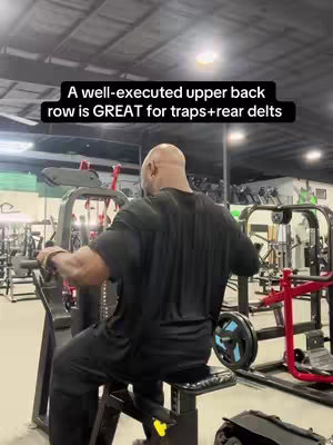 The cover image shows a man in a gym performing an upper back row exercise on a specialized machine. The man is viewed from the back, wearing a black t-shirt. Text overlays at the top explain the benefits of the exercise.