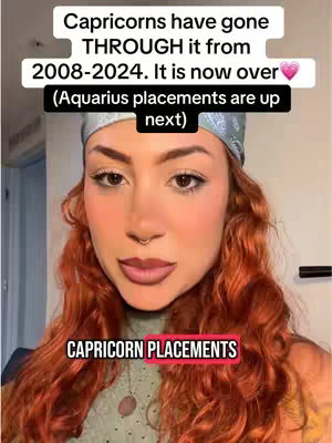 A woman with red curly hair and a light blue headscarf is centered in the frame, looking directly at the camera. Text overlays at the top and bottom of the image contain information about astrology. The background is a softly lit interior.