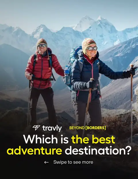 A cover image featuring two people hiking in the mountains. The background shows a snowy mountain range under a clear blue sky. The foreground contains two individuals, a man and a woman, both dressed in hiking attire with backpacks and trekking poles, suggesting an adventure tourism theme.
