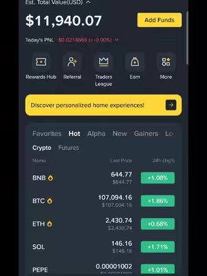 A screenshot of a cryptocurrency trading app interface. The layout is dominated by a light background with white and black texts and elements. At the top, it displays the "Est. Total Value" in USD, showing a balance of $11,940.07. Underneath, it indicates the "Today's PNL" and a small percentage change. Several icons are present, including "Rewards Hub," "Referral," "Traders League," and "Earn." The central part of the interface features a scrolling list of cryptocurrencies such as BNB, BTC, ETH, SOL, and PEPE, listing their current prices and 24-hour changes indicated by a percentage. The "Hot" button is highlighted.