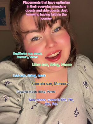 A selfie-style image featuring a woman smiling and looking at the camera. Overlayed text provides astrological sign details in various colors, against a background with subtle lighting.