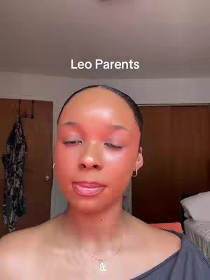 The cover image is a close-up shot of a person's face, primarily focusing on the face with closed eyes. The face has a red hue, possibly due to makeup or a filter. Above the face is a banner that displays the text: "Leo Parents". The setting seems to be indoors, with a glimpse of a door and a bed in the background. The person is wearing a dark garment and a necklace with a pendant.
