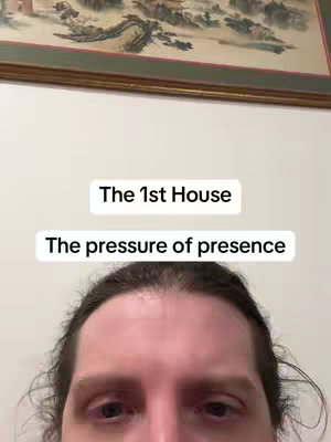 The cover image is a selfie-style shot featuring the upper face of a man with brown hair. He is centered in the frame, with the top of his head cut off. Two text boxes overlay his forehead: the top box reads "The 1st House", and the bottom, larger box says "The pressure of presence". Behind the man is a light-colored wall with a framed picture hanging above, partially visible. The focus is clearly on the man's face and the text, and the composition is simple and direct.