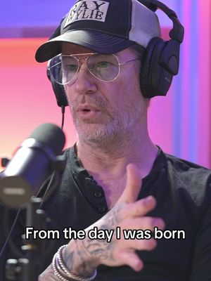The cover image shows a man with a beard, glasses, and a hat, wearing headphones and holding a microphone. Text is overlaid at the bottom.