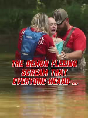 The image captures a moment of spiritual cleansing and healing. Three individuals stand in water; a woman in the middle displays obvious distress, possibly crying. Her arms are held by two people on either side. The person on the left is wearing a blue backpack, and the person on the right, wearing a camouflage hat, is looking at the woman, with a beard. The colors appear muted, and the overall composition conveys a sense of solemnity and intensity.