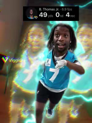 The cover image features a young Black man dressed in a teal football uniform, appearing to run with an excited expression. Duplicate, semi-transparent images of him are layered behind, and electric blue lines surround him, set against a blurry indoor background. Text in a black box shows player stats, the logo of the app 'Viggle' appears on the lower left corner.