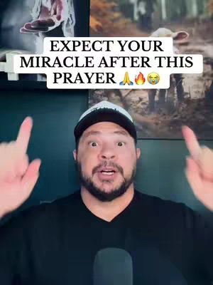 The image showcases a man with an excited expression, pointing upwards towards overlaid text. Above him, a glimpse of what appears to be a religious painting or image can be seen, creating a background with blurred visual elements. The man has dark hair and a black shirt, wearing a cap. The text informs the viewer to 'EXPECT YOUR MIRACLE AFTER THIS PRAYER'. The overall composition utilizes a straightforward, eye-level perspective, with a focus on visual appeal.