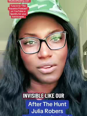 A close-up selfie of a Black woman wearing glasses and a green cap.
She’s looking directly at the camera and speaking. Text overlays include astrological references and movie information.