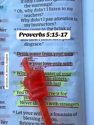The image shows a page from a Bible with several verses highlighted in yellow. A red plastic hand prop partially covers the text. A white rectangular overlay provides the text "Proverbs 5:15-17". The text appears on an open book.