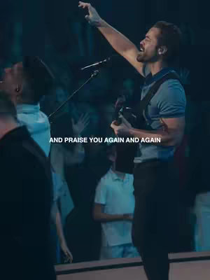 The cover image features a man singing with his arm raised and a guitar in hand, facing right. He is on stage, with dim lighting emphasizing the performer and creating depth. In the background, there is a blurred audience, indicating a worship or concert setting.