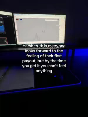 The cover image shows a dark room setup with a desk. Two computer monitors are visible, with one displaying a trading platform interface, and the other showing some other app. The desk itself has a minimalistic setup with a mouse. The image is lit by the monitors and some subtle blue light.