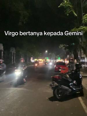 The cover image shows a nighttime street scene with a motorcycle in the foreground, illuminated by streetlights and vehicle headlights creating a bokeh effect. Text overlayed on the image reads "Virgo bertanya kepada Gemini".
