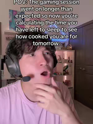 A selfie-style shot features a young person with dark hair, wearing a headset with a microphone, against a cluttered room. Overlay text is added at the top, and the person's face shows an open mouth and startled expression, possibly indicating surprise or realization.
