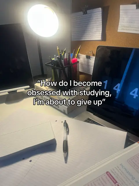A desk setup with a laptop displaying a timer, books, notes, and a pen. A bright light from a lamp illuminates the scene, with text overlayed about studying.