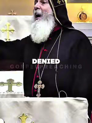 The cover image is a frame from a video. It shows a man, presumably a religious figure, dressed in dark robes, speaking passionately. The background is blurred, but suggests an indoor setting, possibly a church or a lecture hall. The man has a white beard and is wearing a cross around his neck. Text overlayed on the image. The lighting appears to be artificial, casting shadows that add to the scene's intensity.