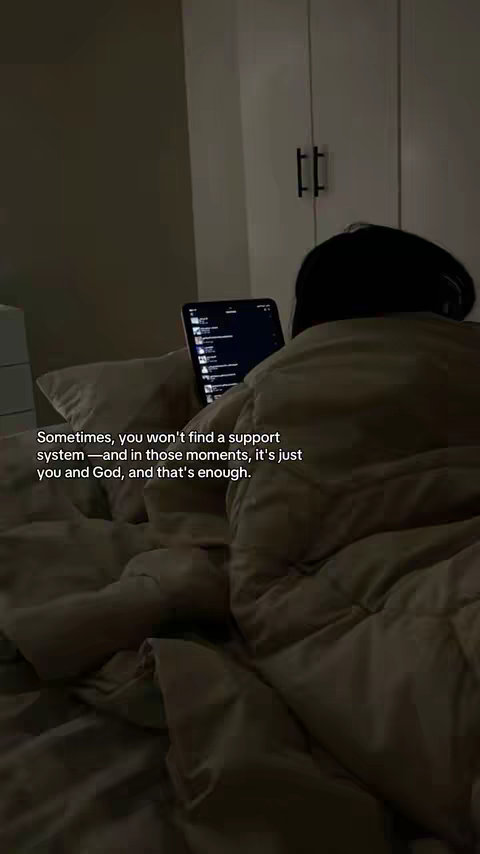 The image shows a person, mostly obscured by a blanket, lying in bed. A tablet with a lit screen displaying a list of items is visible. The scene is dimly lit with warm tones. The text overlay is centered on the lower half of the frame.