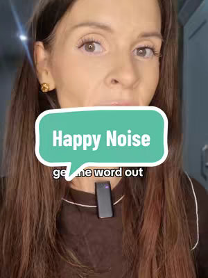 A woman with long brown hair looks directly at the camera, wearing a brown top. Overlaid on her face is a teal speech bubble containing the text "Happy Noise" and the text "get the word out". A small black microphone is clipped to her shirt.