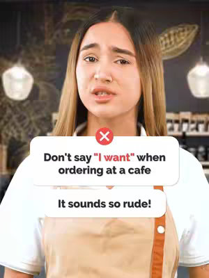 A medium shot shows a woman with long blonde hair in a white shirt and tan apron, looking directly at the viewer with a slightly concerned expression. Overlayed on the image is a two-part text box with the words "Don't say 'I want' when ordering at a cafe" shown above a red 'X' icon. Below the first part, and separated in a different box, the text "It sounds so rude!" appears. The background appears to be a cafe setting.