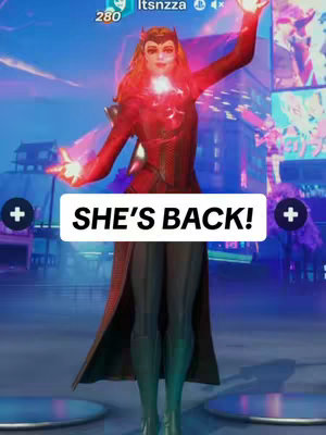 A video game screenshot featuring the character Scarlet Witch from Fortnite. She is centered in the frame against a background of city skyscrapers and bright neon signs. The character wears a red costume, has long red hair, and is posed with her hands outstretched, with red energy effects. The textual overlay on the image reads, 'She's back!'