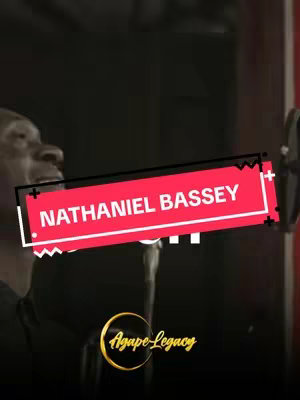 The cover image shows a person partially visible, presumably singing into a microphone. A red rectangular overlay is superimposed, with the words "NATHANIEL BASSEY" in white text. Below this, the text "...