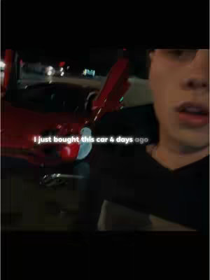 A man is seen from the chest up, holding a phone and filming in a dim, outdoor setting. Behind him, a red sports car is partially visible with its doors open. Text overlaid on the image reads: "I just bought this car 4 days ago."