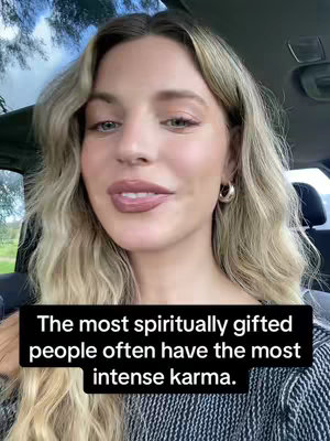 A woman with blonde wavy hair and hoop earrings is in the driver's seat of a car. She has a neutral expression. A black bar at the bottom of the image displays the video's hook text.