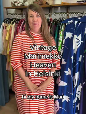 A woman in a red and white striped dress stands in a shop filled with colorful clothing racks. Text overlays read "Vintage Marimekko Heaven in Helsinki" and "hi my name is Mari."